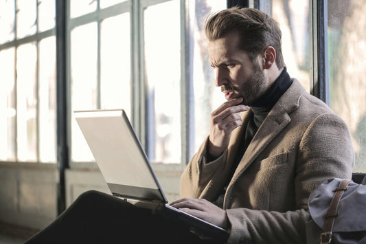 Business executive working in an airport. Photo by Bruce Mars on Unsplash.
