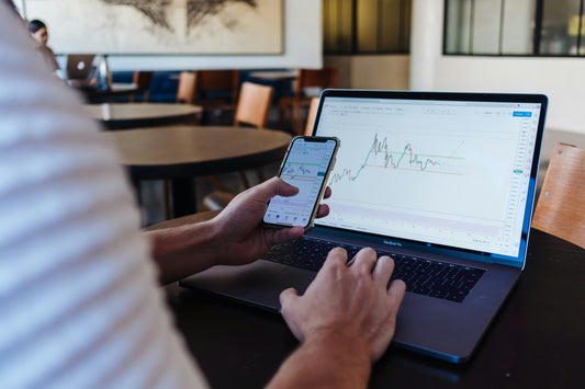 Man trading stocks on his laptop. Photo by Jason Briscoe on Unsplash.