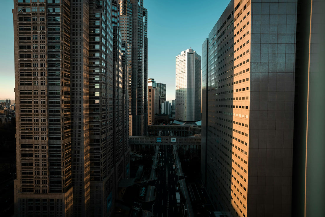 Office towers in Nishi-Shinjuku, Tokyo, with sleek skyscrapers and a central street leading through the urban landscape.